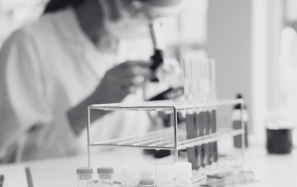 Researcher and Test Tubes - 950x600-1